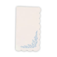 Blue floral paper guest towel with scalloped edge and botanical corner design.
