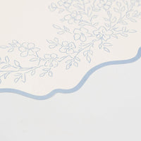 detailed floral illustration on blue paper placemat border.