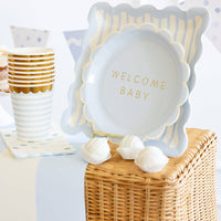 Baby blue polka dot napkins styled with blue baby shower plates and cups
