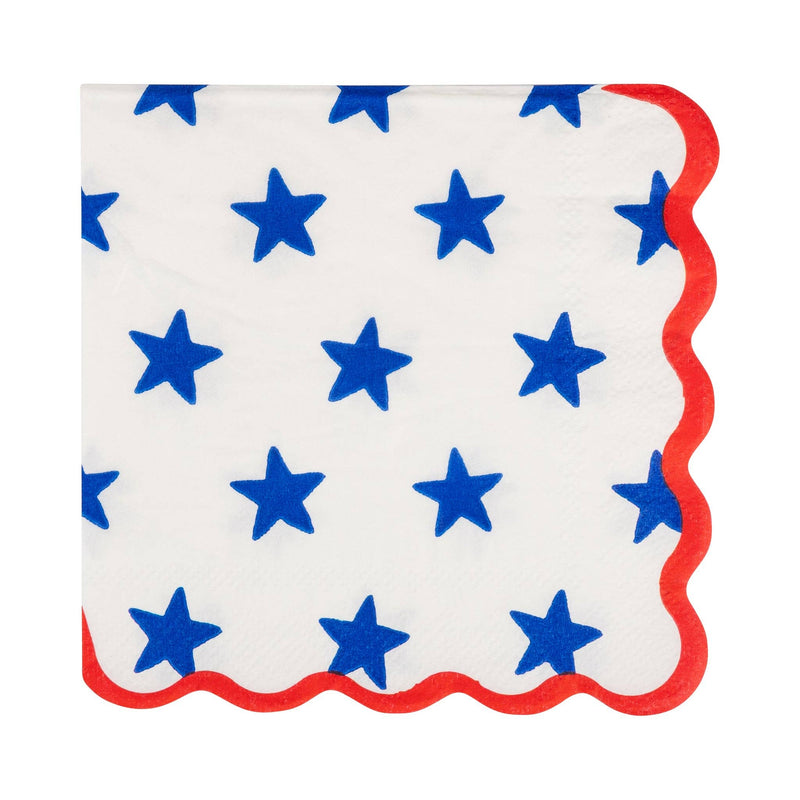 Blue star print scalloped paper cocktail napkin on cream background with red scalloped edge