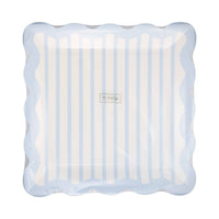 Stack of blue striped scalloped plates in clear packaging