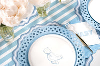 Blue teddy bear dessert plate on a blue and white striped table with peonies in glass vases