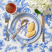 Blue toile napkins styled with tea, pastries, and place setting