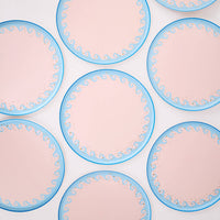 Repeating pattern of blue wave dinner plates showing the wave scroll border and gold foil detail.