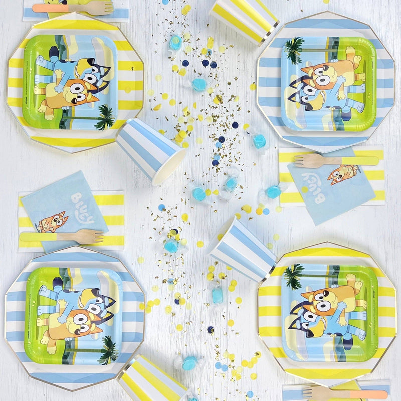 Bluey party table setting with yellow striped guest towels.
