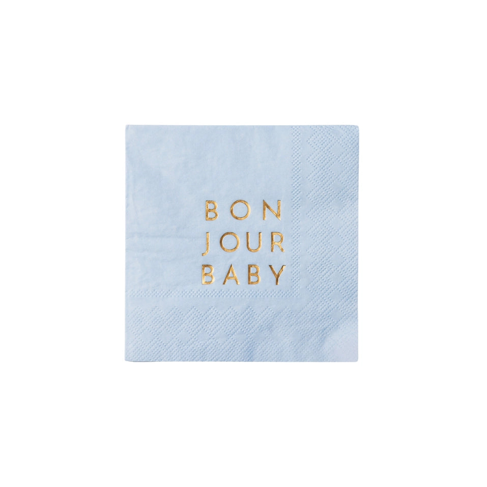 Single sky‑blue cocktail napkin photographed flat to show gold‑foil text and subtle texture.