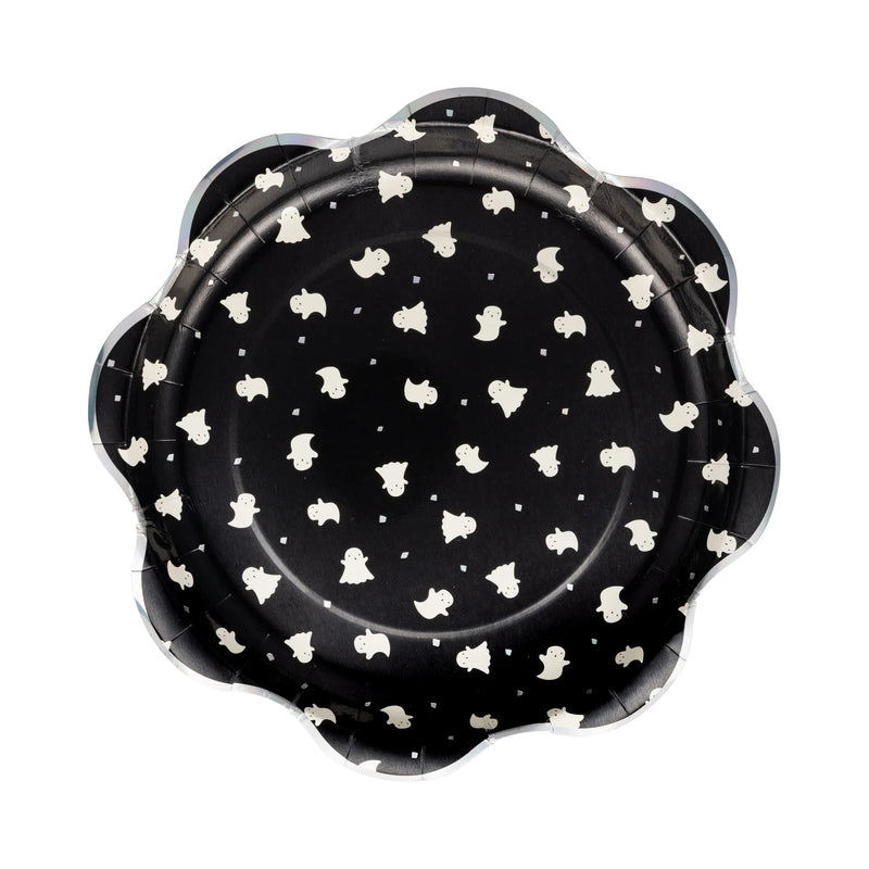 Isolated hero shot of single 10-inch Boo Ghost Scatter plate on pure-white background. Eight-petal scallop rim edged in subtle holographic foil; deep black center sprinkled with dozens of cute ivory ghosts drifting among reflective confetti, evoking starlit sky. Slight drop shadow shows rigid 400 gsm thickness able to hold chili, sandwiches, or cupcakes without sagging. High-resolution image showcases pattern density, foil sheen, and playful design perfect for mix-and-match Halloween party setups.