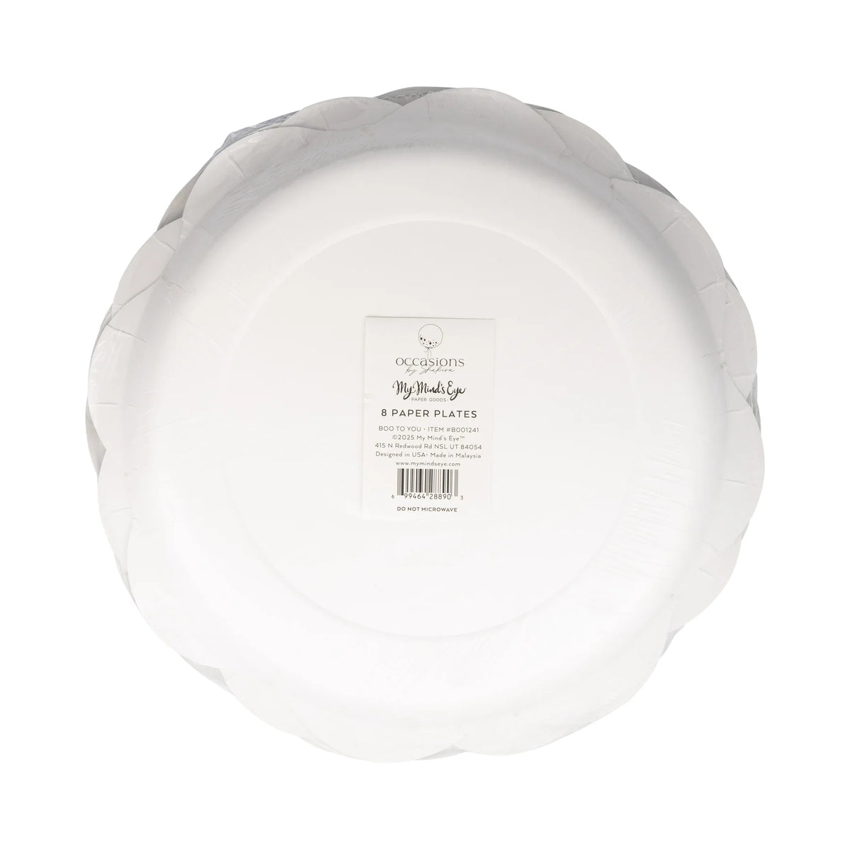 Shrink-wrapped eight-count Boo Ghost Scatter plate pack lying label-side up. Clean white plate backs reveal sturdy pressed-paper depth; centered rectangle sticker lists My Mind’s Eye branding, item code BOO1241, barcode, FSC logo, and ‘Do Not Microwave’ warning. Transparent film hugs scalloped edges, hinting at hidden holographic foil rim. Studio lights create subtle highlights across cellophane, emphasizing pristine, factory-sealed condition ready for shipping, retail display, or busy-mom party prep.