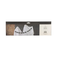 Retail back-of-pack image for Boo felt Halloween banner. Long black header card shows three sheet-clad “ghost” kids in front of gray paneled doors; the six-foot felt pennant garland spells BOO multiple times across their chests, cream pom-poms in between. Right panel lists Occasions by Shakira™ and My Mind’s Eye logos, barcode, item code and 6 ft length, giving online shoppers scale, branding and care info at a glance.