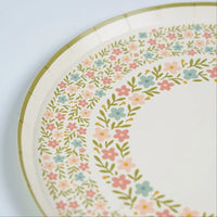 detail of botanical dinner plates showing pastel flower pattern.