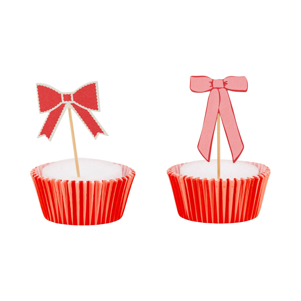 Red and pink bow cupcake topper on red baking liner