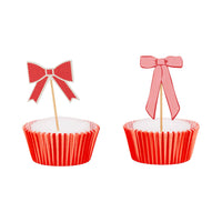 Red and pink bow cupcake topper on red baking liner