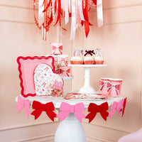 Valentine’s Day table styled with bow patterned heart plates and matching decor