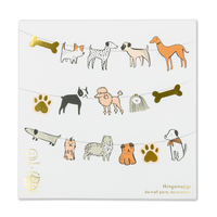 Bow Wow Thingamajigs dog birthday banner pieces with neutral colors and gold foil details in packaging