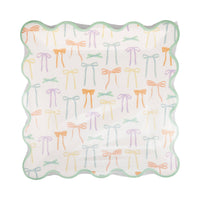 An 8 count set of charming bow adorned paper plates in clear packaging for a Regency Chic party.