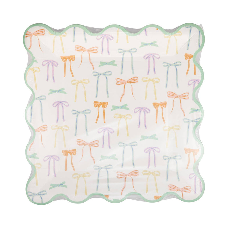 An 8 count set of charming bow adorned paper plates in clear packaging for a Regency Chic party.