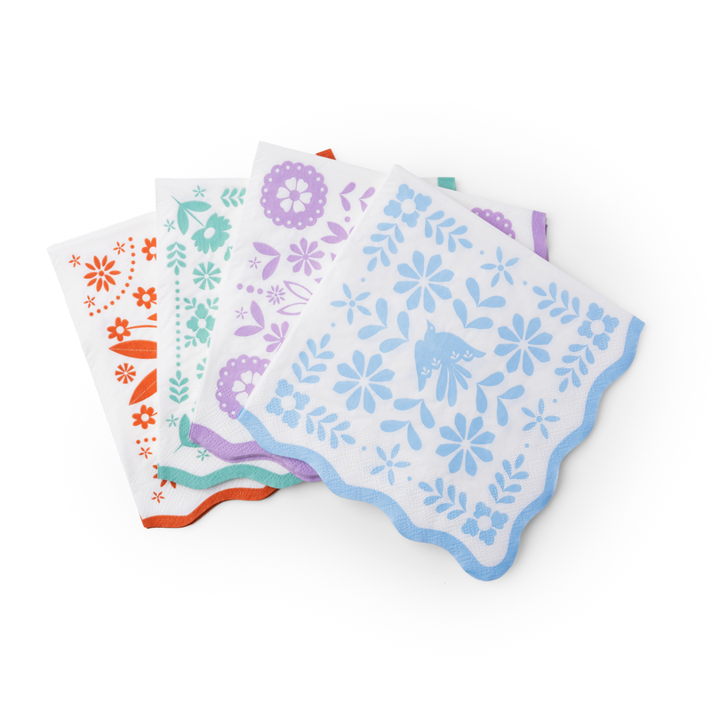 bright fiesta paper napkins with colorful floral designs and scalloped edges
