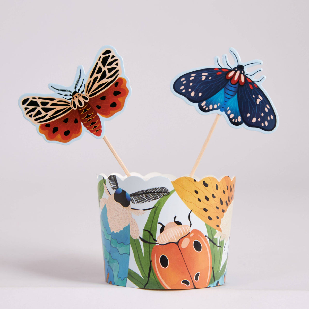 Bug baking cup with two butterfly and moth cupcake toppers