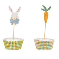 Close-up of a white bunny with a blue bow and an orange carrot cupcake topper in gingham liners, perfect for spring garden party decorations.