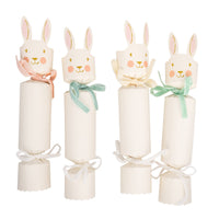Set of Easter bunny party crackers with pastel ribbon bows on white background