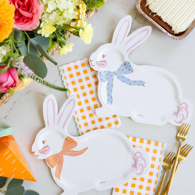 Bunny shaped paper plates styled on Easter table with gingham napkins and flowers