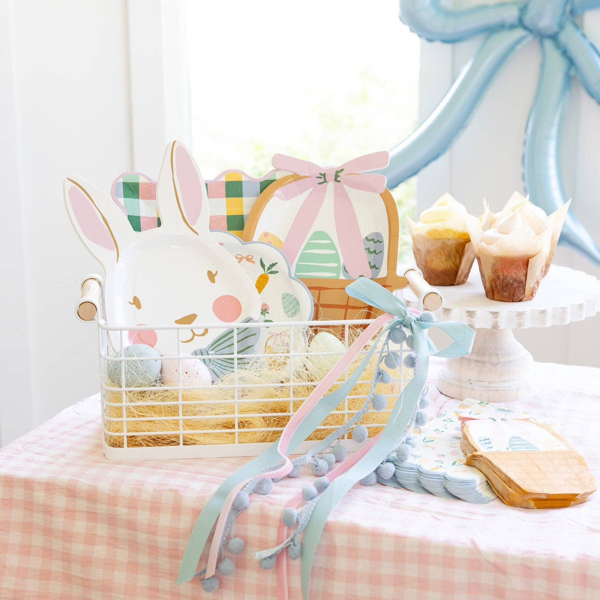 Bunny shaped plates displayed in Easter basket with coordinating party decor