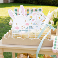 Bunny face plates styled outdoors with spring table setting and seasonal decorations