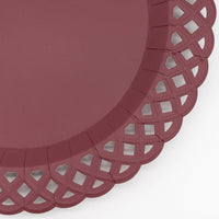 Angled view of the burgundy dinner plate showing the lattice border and embossed detail.