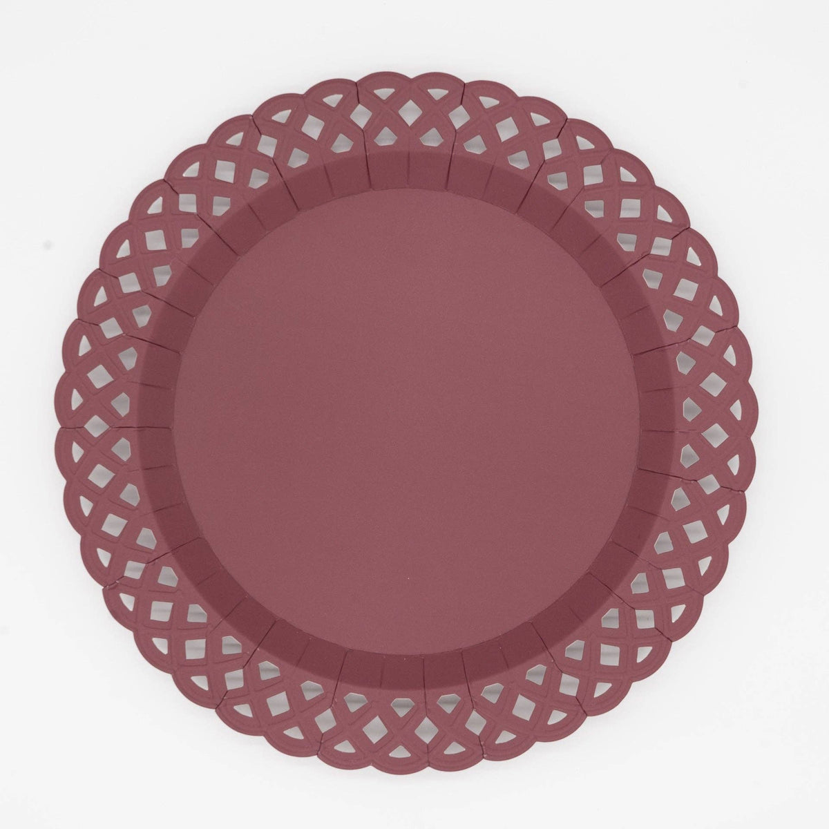 Deep burgundy dinner plate with an embossed basketweave texture and a lattice cutout scalloped border, overhead view on white background.