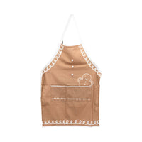 Gingerbread Apron – Adult displayed flat to show design details, including two front pockets and white icing-style trim.