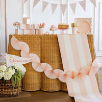 Close view of pink striped table runner with party details