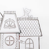 Close up detail of a smiling cat line-art drawing sitting on the highest roof peak of the haunted house.
