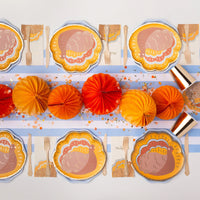 Long Thanksgiving tablescape with Charming Turkey plates and white guest towels printed with a turkey and “Happy Thanksgiving.”