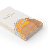 Angle view of a stacked pack of turkey guest towels showing gold details on the tail.