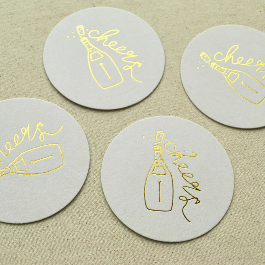 Set of four round Cocktail Coasters with champagne bottle and cheers design—ideal for engagement supplies party.
