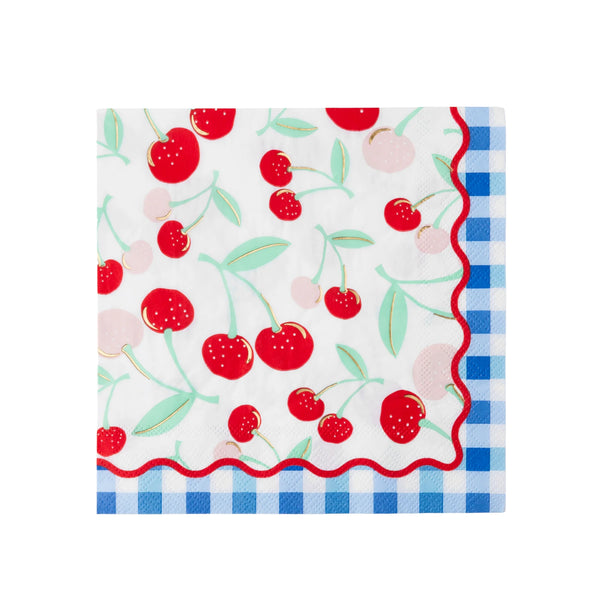 Single cherry print paper lunch napkin laid flat showing gold-foil cherries, mint stems, red rickrack edge, and blue gingham corner border.