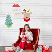 Lifestyle scene with child on phone under 3D Christmas hanging decorations (Santa, reindeer, tree)