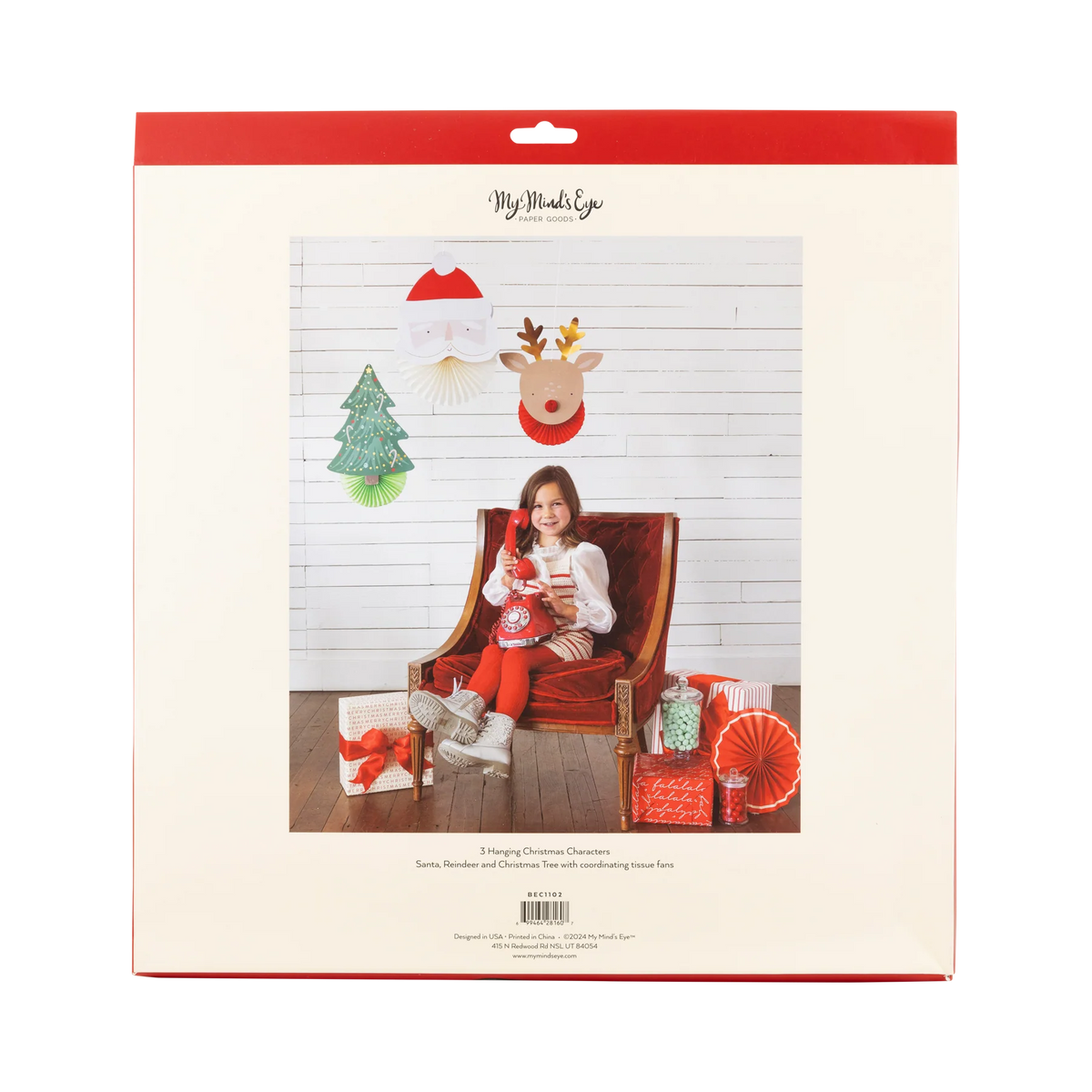 Back of package showing child scene with Santa, reindeer, and tree Christmas hanging decorations