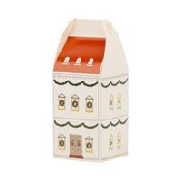 Cream house-shaped advent box with a red scalloped roof, garland swags, and wreaths in the windows