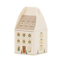 Cream house-shaped advent box with a taupe roof, gold foil shutters, wreaths, and potted topiaries by the door