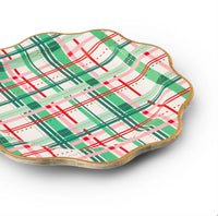 Side view stack showing scalloped rim and gold edge on large Christmas paper plates with green, red, and pink plaid.