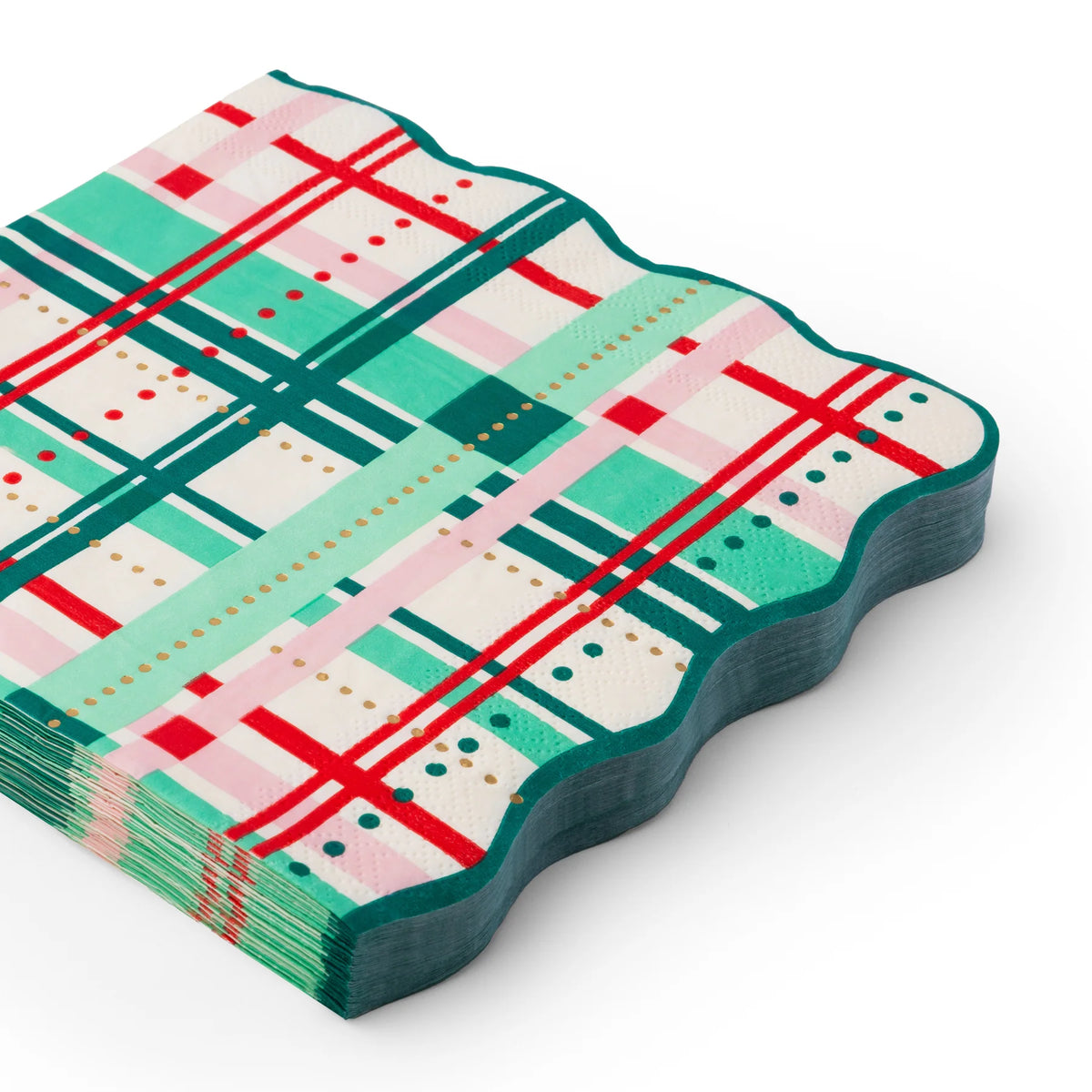 Stack of scalloped Christmas paper napkins in red, pink, and green plaid with gold foil accents.