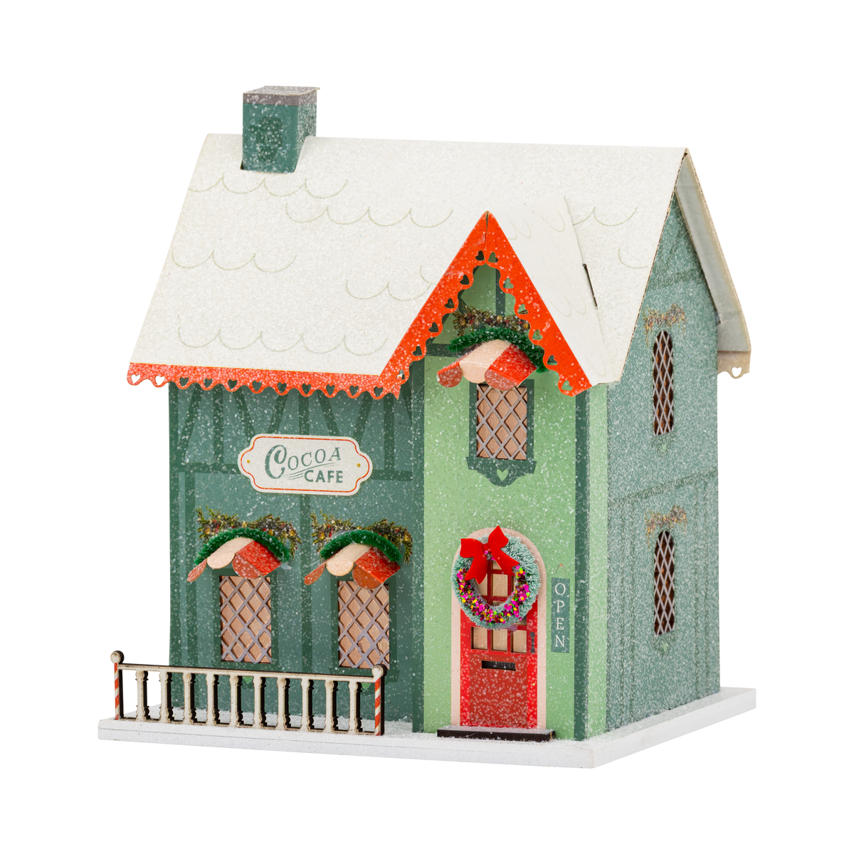 Green glitter cocoa cafe putz house with snowy roof, red door wreath, and candy striped porch rail