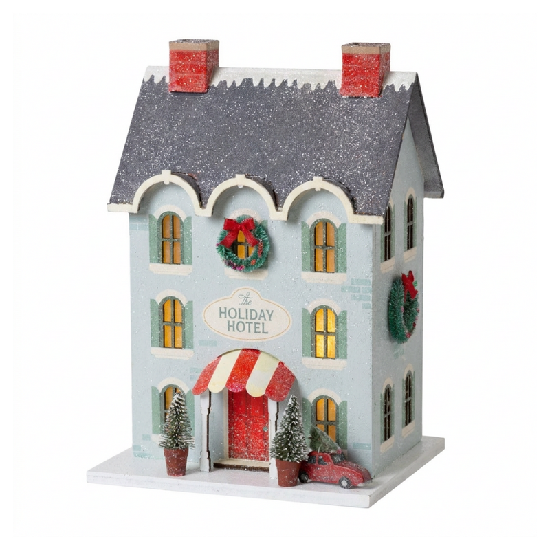 Blue glitter Holiday Hotel putz house with silver roof, wreaths, striped awning, and red car with tree