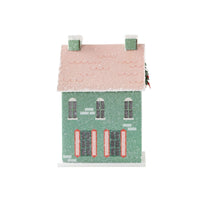 Back view of the mint Christmas house showing the pink glitter roof and shuttered windows