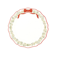 Cream scalloped wreath dinner plate with a red rim, an evergreen wreath, red berries, and a red ribbon bow.