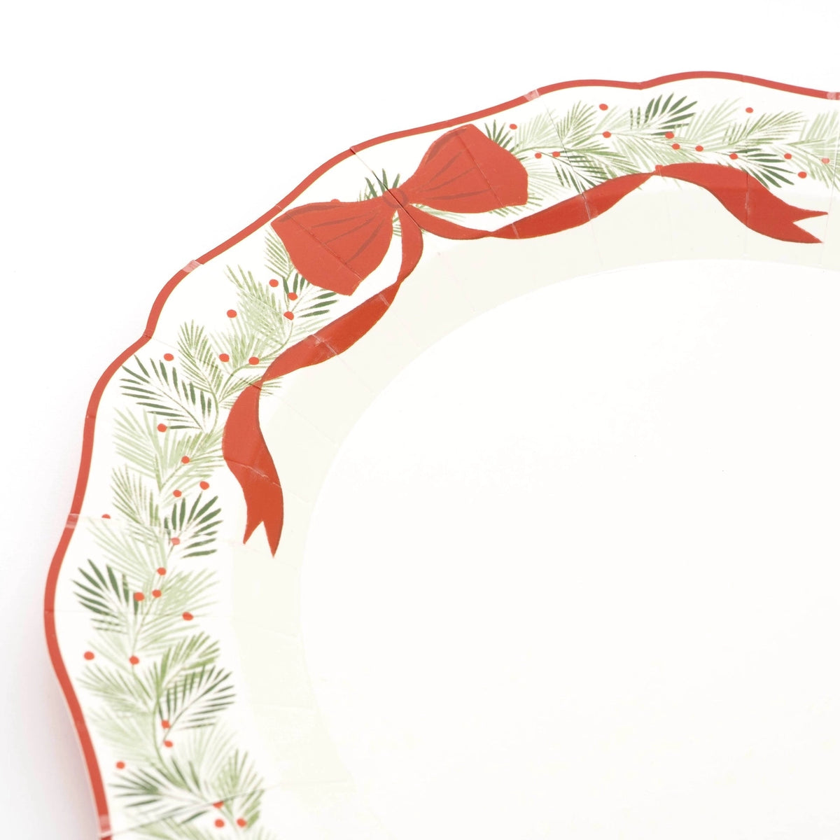 Close-up of the wreath dinner plate showing the red bow, evergreen wreath, and red berries.