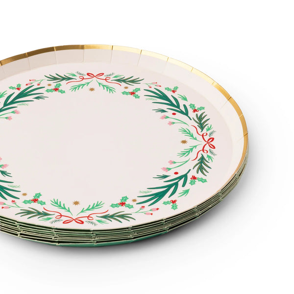 Side stack of wreath dessert plates showing gold rim and evergreen artwork—classic Christmas paper plates.
