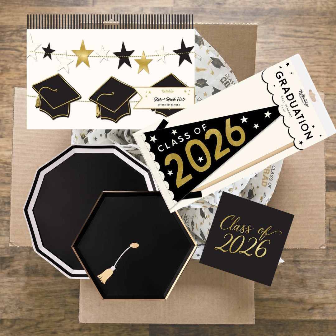 Class of 2026 graduation party kit contents in shipping box including plates, napkins, pennant, and banners