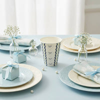 Blue party cup styled on a tablescape with light blue plates and gift boxes